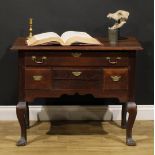 An 18th century oak lowboy, rectangular top with reentrant foreangles above four drawers, shaped