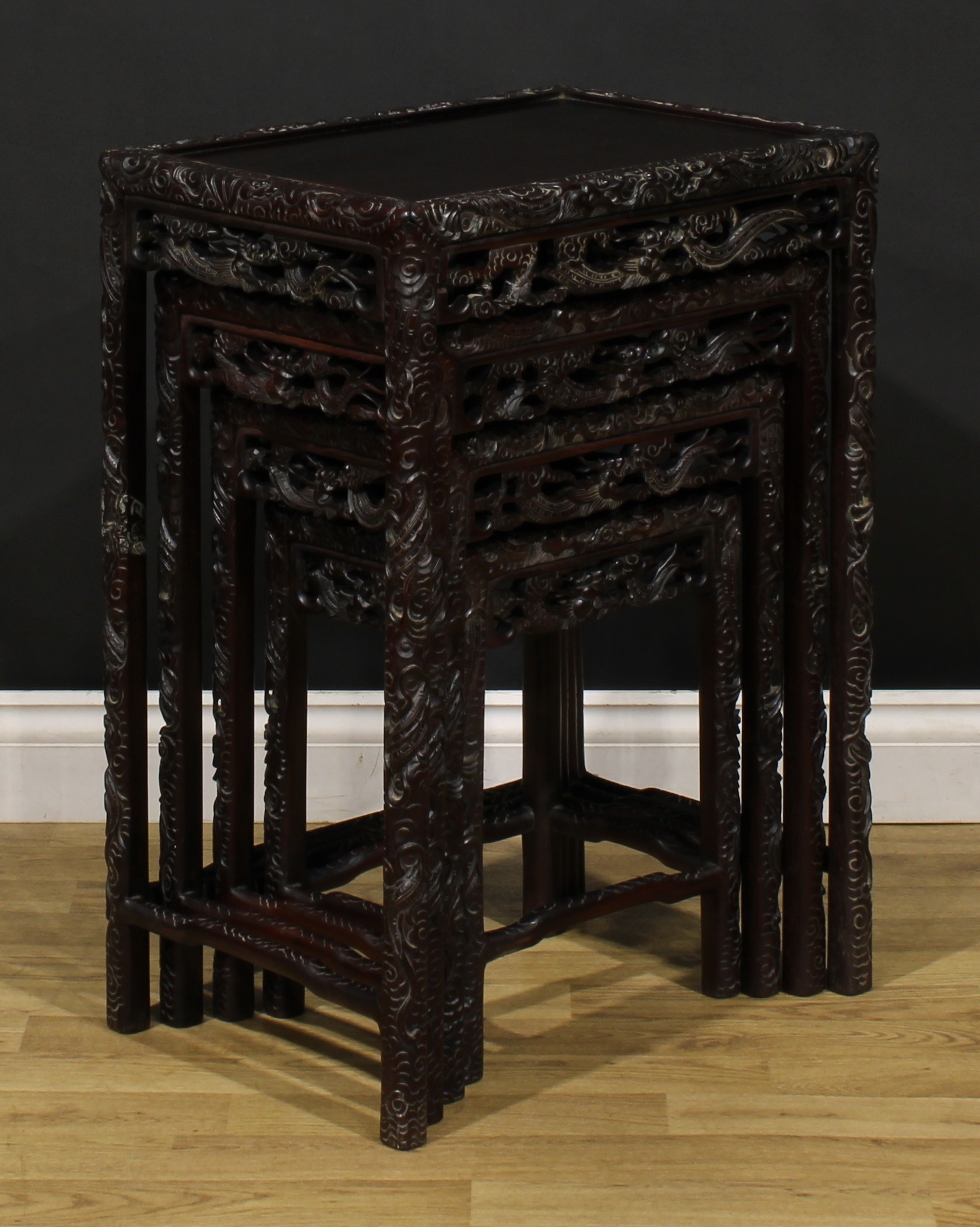 A set of Chinese hardwood quartetto tables, each carved throughout with dragons, the largest 70. - Image 4 of 6