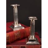 A pair of George V silver fluted Corinthian column candlesticks, beaded borders, stepped bases, 18cm