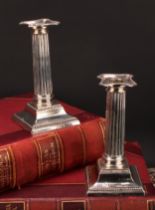 A pair of George V silver fluted Corinthian column candlesticks, beaded borders, stepped bases, 18cm