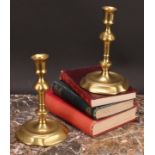 A pair of George II brass candlesticks, of seamed construction, knopped pillars, dished quatrefoil