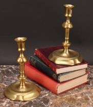 A pair of George II brass candlesticks, of seamed construction, knopped pillars, dished quatrefoil