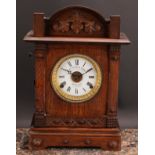 An early 20th century oak mantel alarm clock, 11.5cm circular enamel dial inscribed FATTORINI &