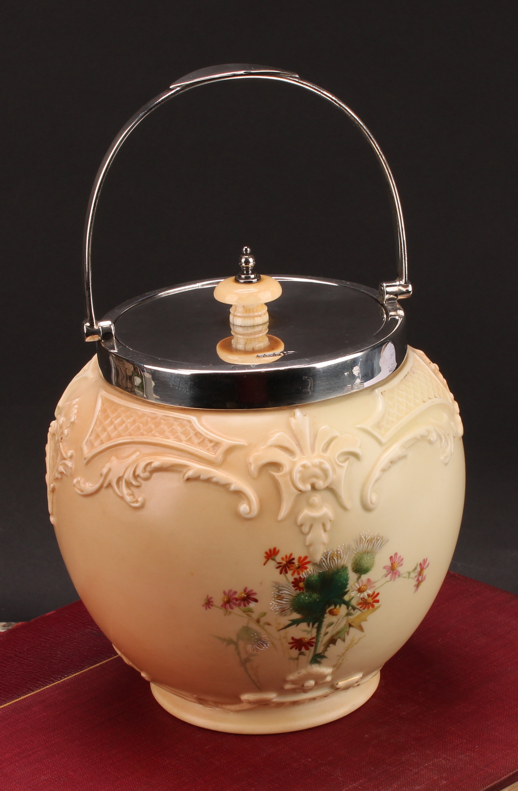 A Royal Worcester Hadley silver mounted ovoid biscuit barrel, moulded in relief and decorated in