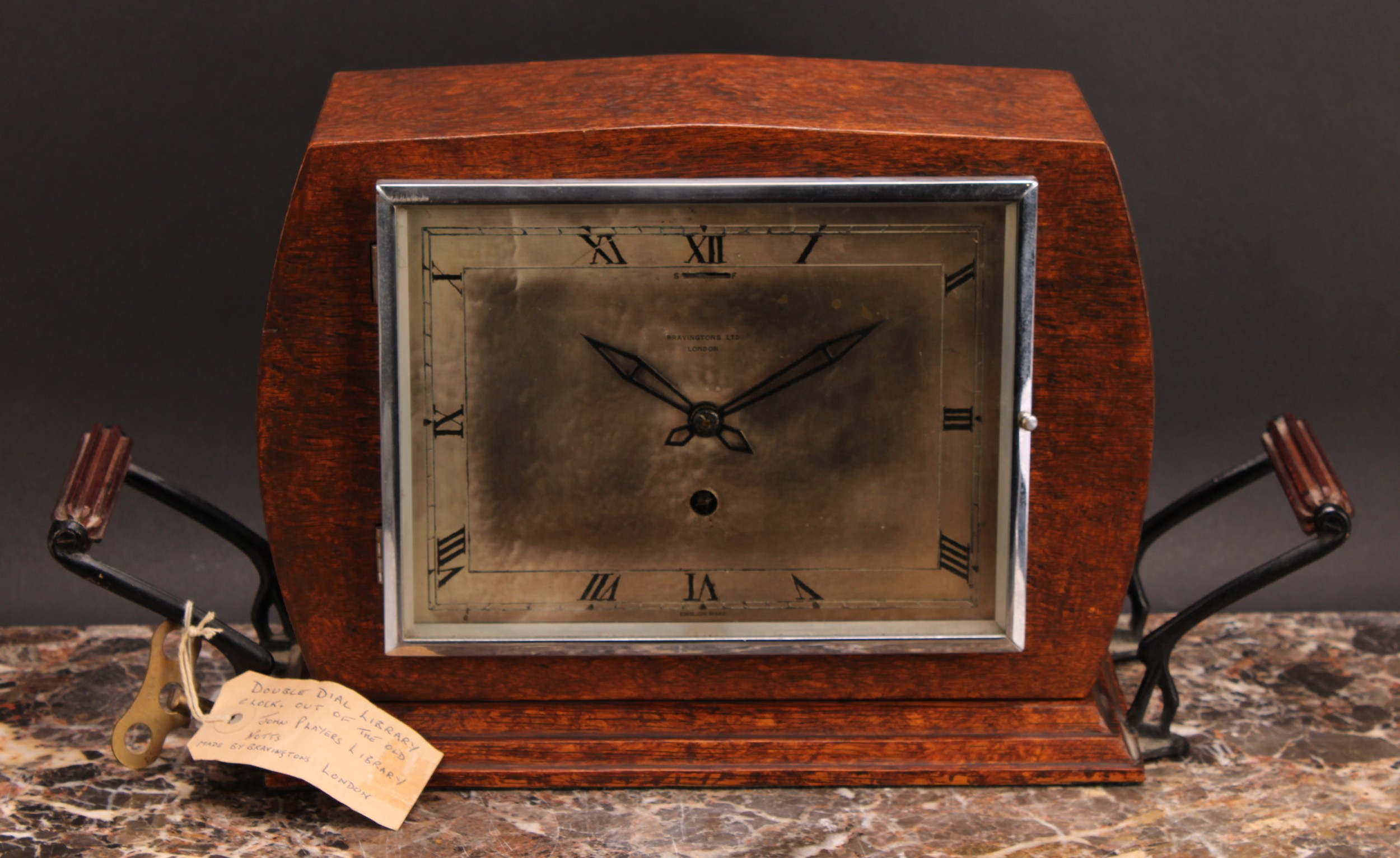 An early 20th century oak double-dial club timepiece, 20cm rectangular silvered dial inscribed