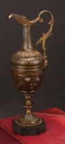 A 19th century Grand Tour ewer, cast with flowers and foliage, scroll handle, knopped stem, black