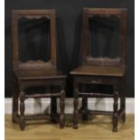 A near pair of 17th century oak backstools, boarded seats, turned legs and stretchers, one