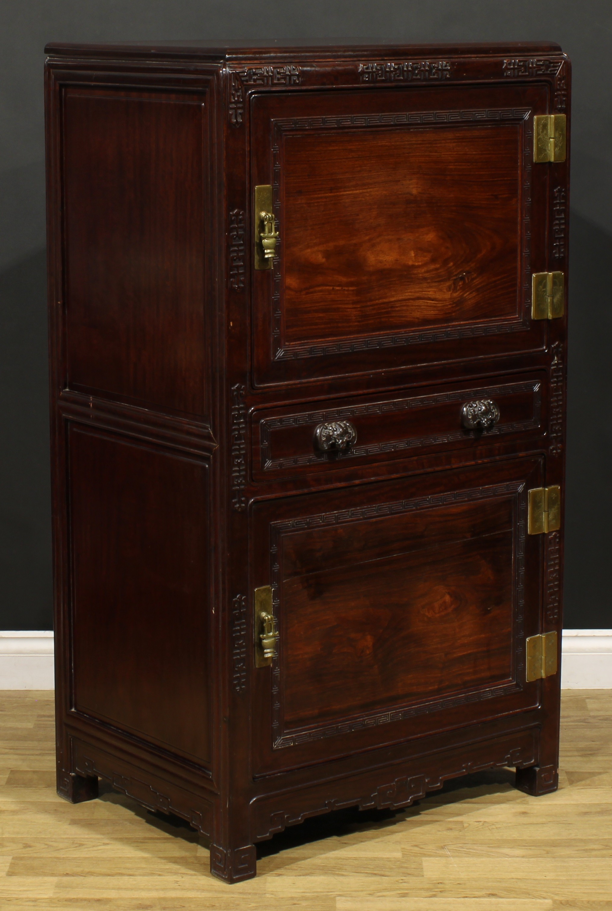 A Chinese hardwood side cabinet, moulded rectangular top above two panel doors centred by a long - Image 2 of 5