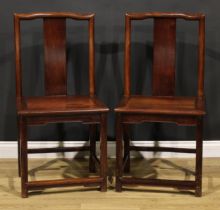 A pair of Chinese hardwood chairs, serpentine cresting rails, panelled seats, square legs,