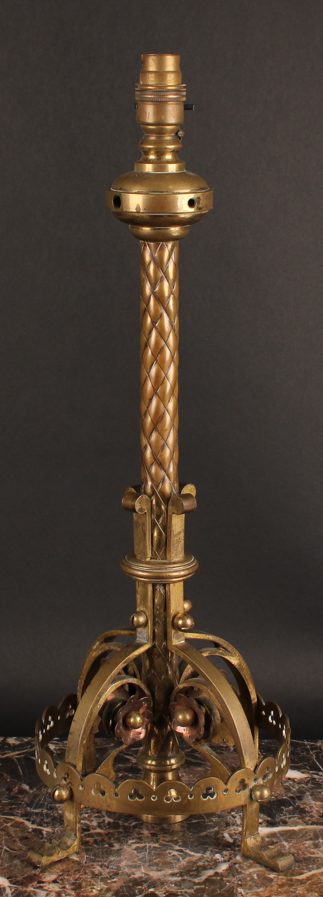 A Neo Gothic brass and copper table lamp, in the manner of William Burgess, the circular base