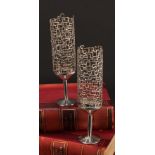 Stuart Devlin (1931 - 2018) - a pair of Elizabeth II silver candlesticks, pierced textured storm