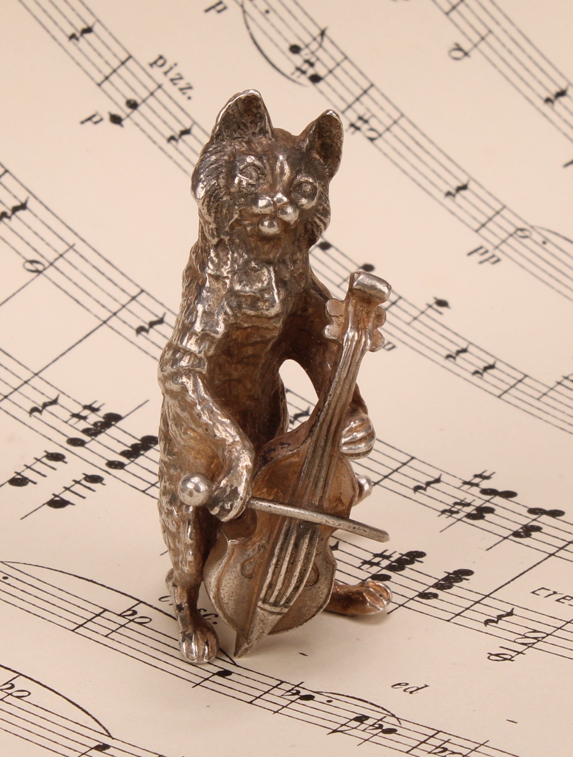 An Elizabeth II silver novelty miniature model, cast as a cat playing a cello, 6cm high