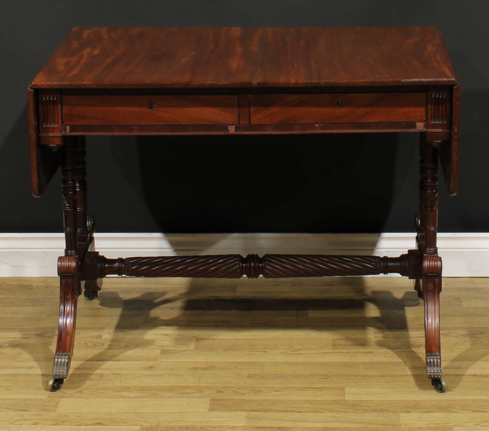 A Regency mahogany sofa table, possibly Irish, rounded rectangular top with fall leaves above a pair - Image 2 of 7