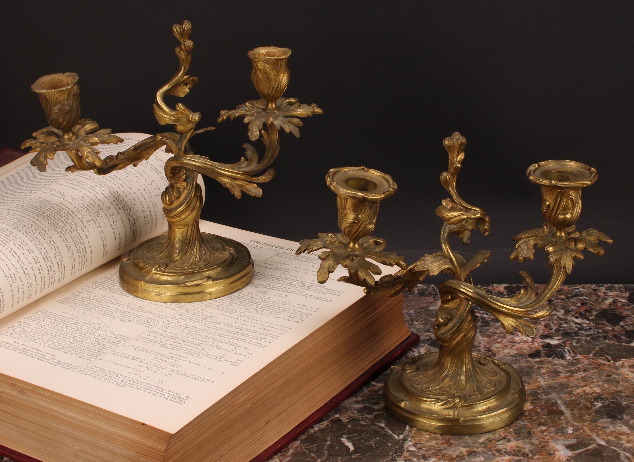 A pair of 19th century gilt brass two-light candelabra, cast with scrolling acanthus, 21cm high, c.
