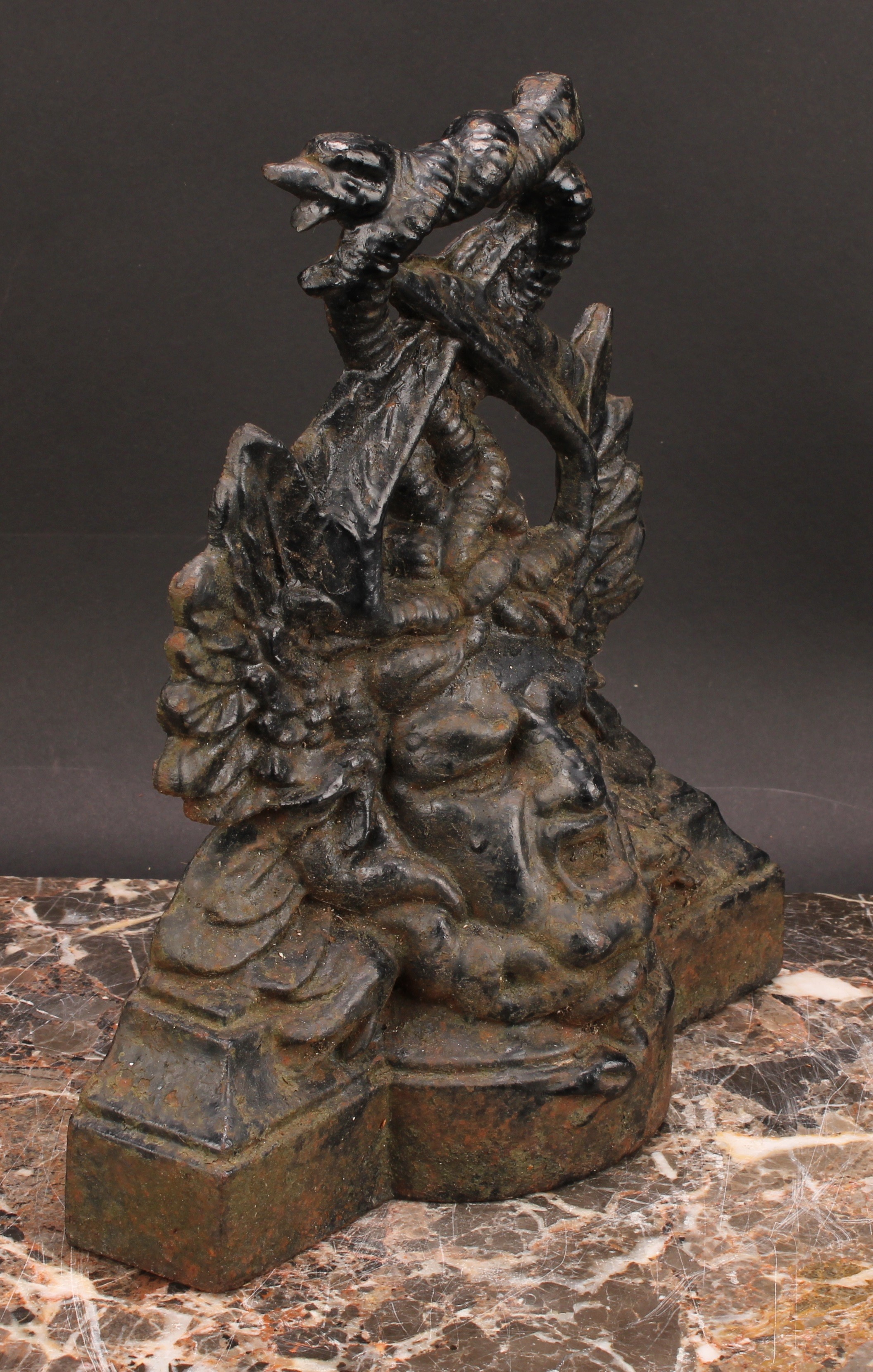 A Victorian cast iron door stop, in bold relief with a mask and entwined dolphins, 27cm high, - Bild 3 aus 3
