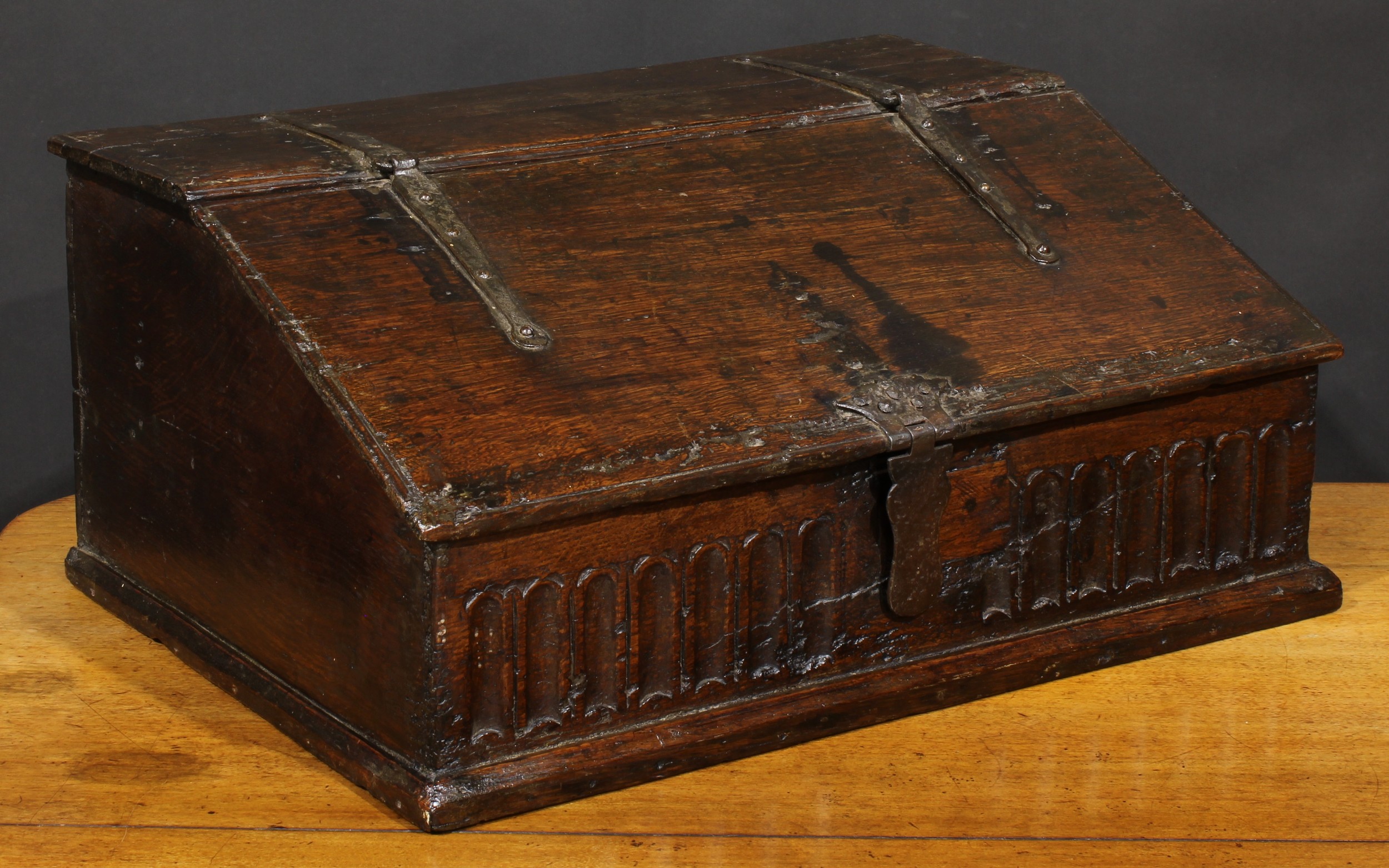 An 18th century oak boarded table box, hinged sloping top above a nulled frieze, 29cm high, 63.5cm - Image 2 of 4