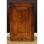 A George III mahogany banded oak splay-front corner cabinet, reeded cornice above a panel door and a