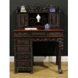A Chinese export hardwood desk, inverted break-centre superstructure with shaped three-quarter