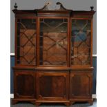 A Chippendale Revival mahogany break-centre library bookcase, astragal glazed doors, the