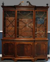A Chippendale Revival mahogany break-centre library bookcase, astragal glazed doors, the