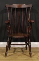 A 19th century beech and elm penny seat elbow chair, in the Windsor tradition, turned legs, H-