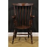 A 19th century beech and elm penny seat elbow chair, in the Windsor tradition, turned legs, H-