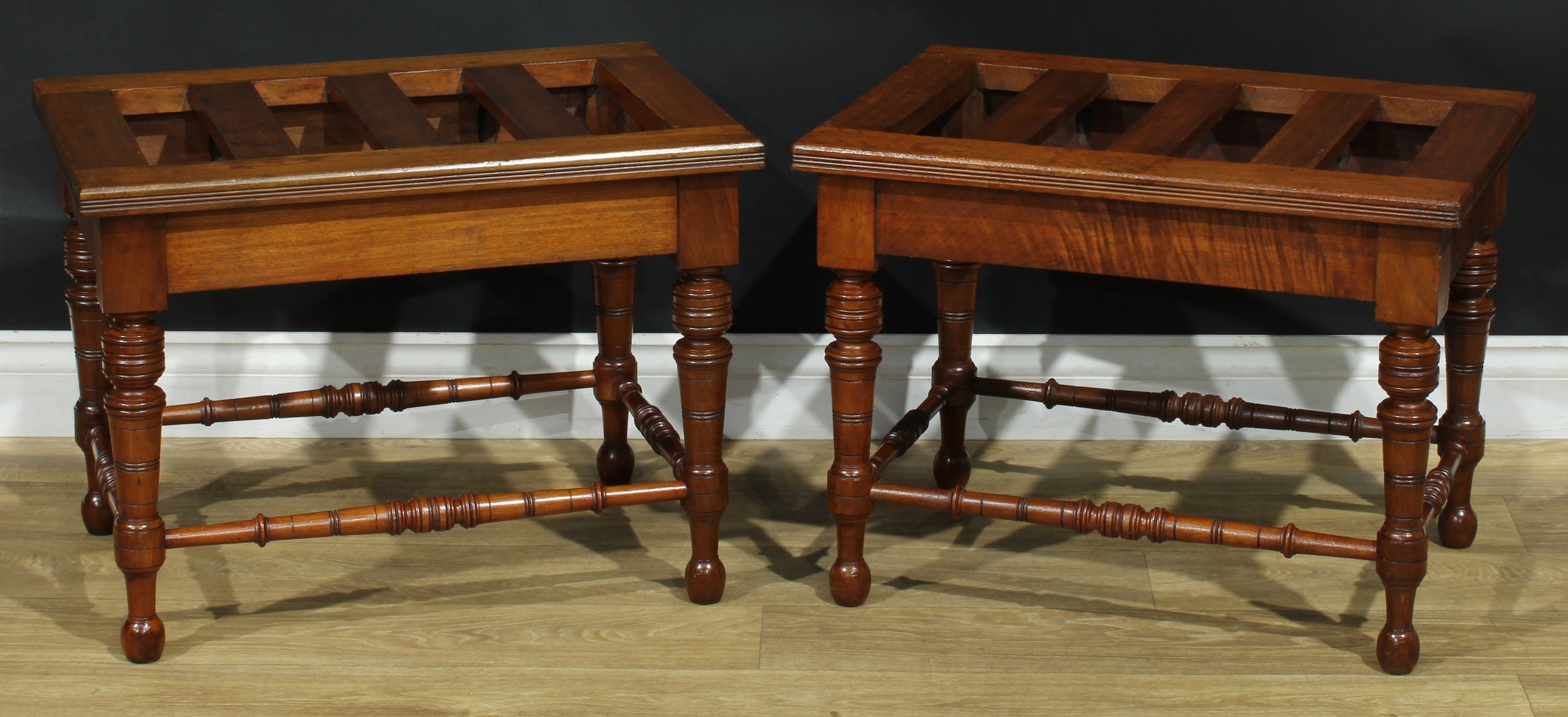 A pair of late Victorian walnut and mahogany rectangular luggage stands, each with oversailing