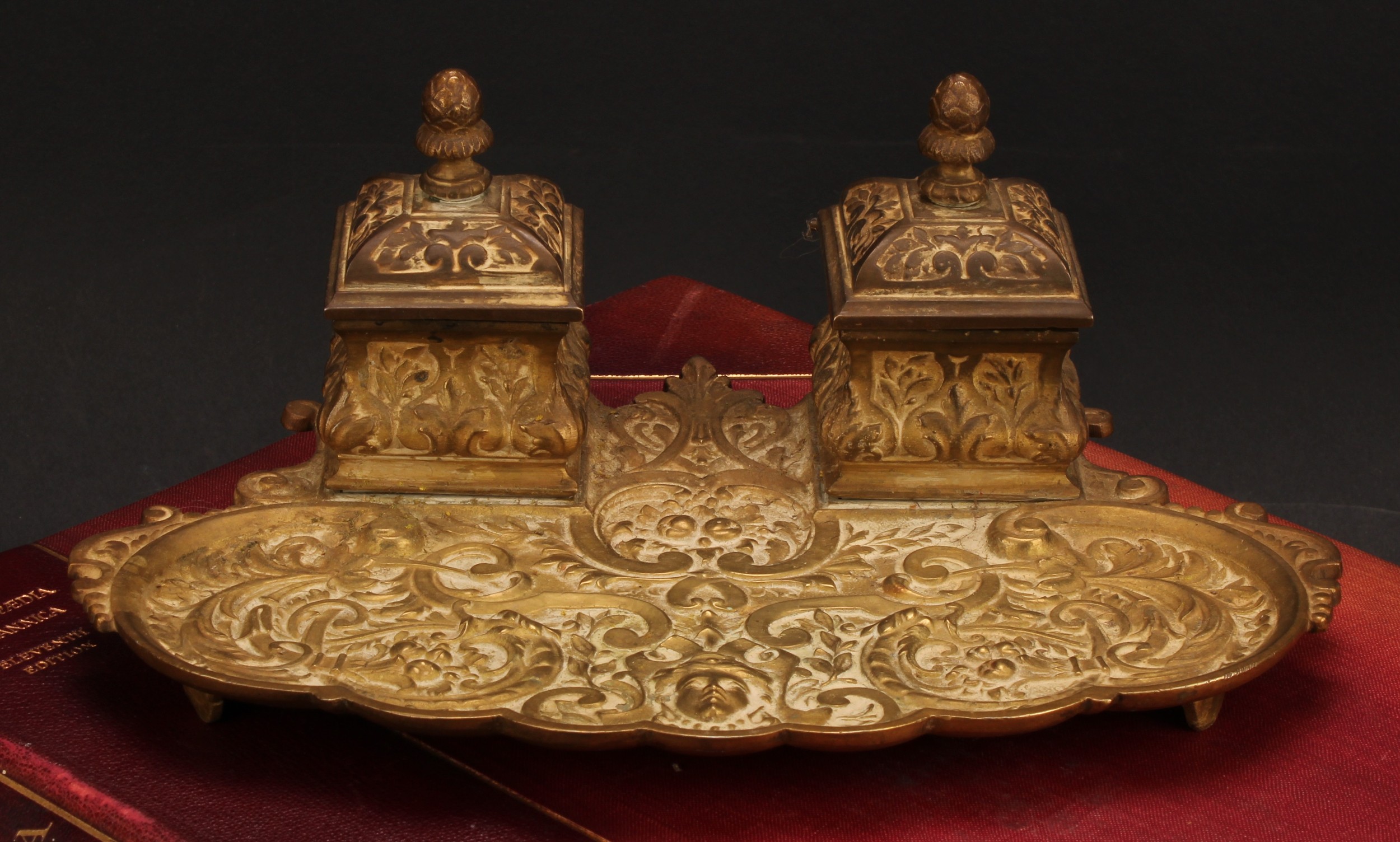 A 19th century gilt bronze inkstand, cast in the Renaissance Revival taste with masks, leafy
