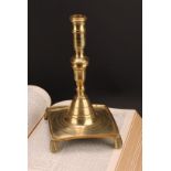 A Spanish brass tray base socket candlestick, knopped pillar, domed socle, fluted feet, 25cm high,