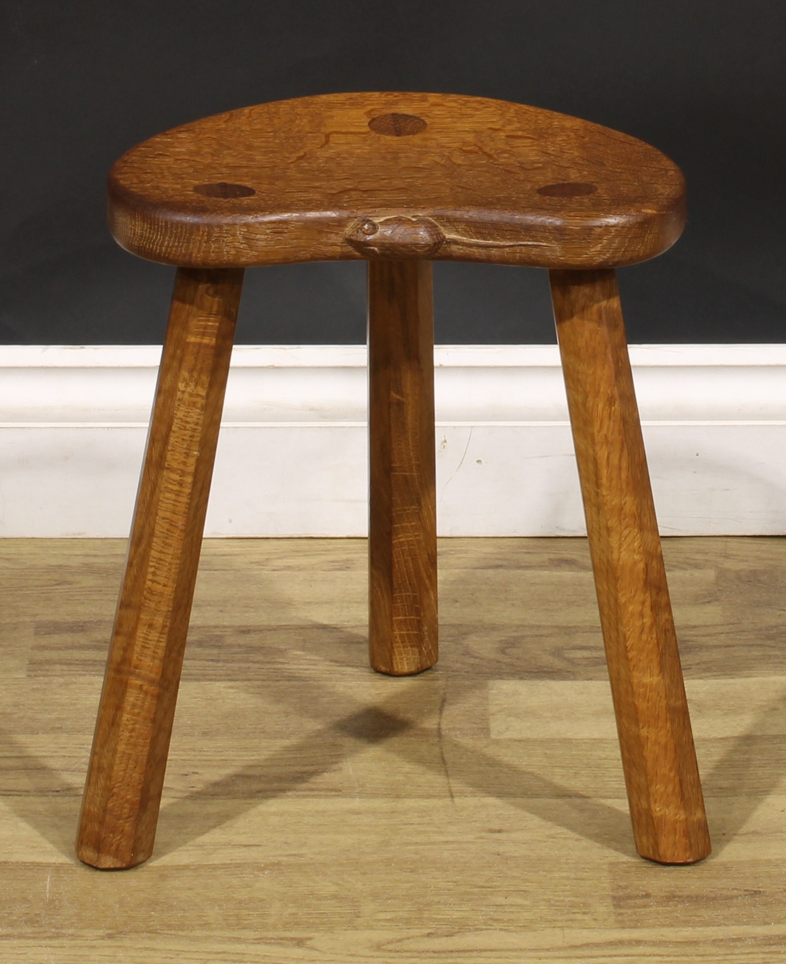 Robert Thompson, Mouseman of Kilburn, an oak milking stool, carved mouse signature, 35.5cm high,