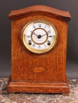 An early 20th century oak mantel clock, 10cm circular dial inscribed MANUFACTURED BY SEIKOSHA,