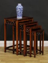 A set of Chinese hardwood quartetto tables, each with rectangular panel top above a shaped frieze