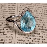 An impressive topaz and 18ct white gold ring, the large sky blue pear shape facet cut stone set