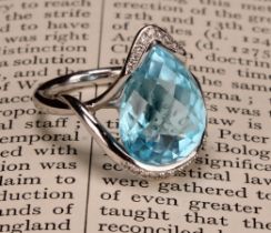 An impressive topaz and 18ct white gold ring, the large sky blue pear shape facet cut stone set