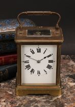 An early 20th century lacquered brass carriage clock, 6.5cm rectangular dial inscribed with Roman