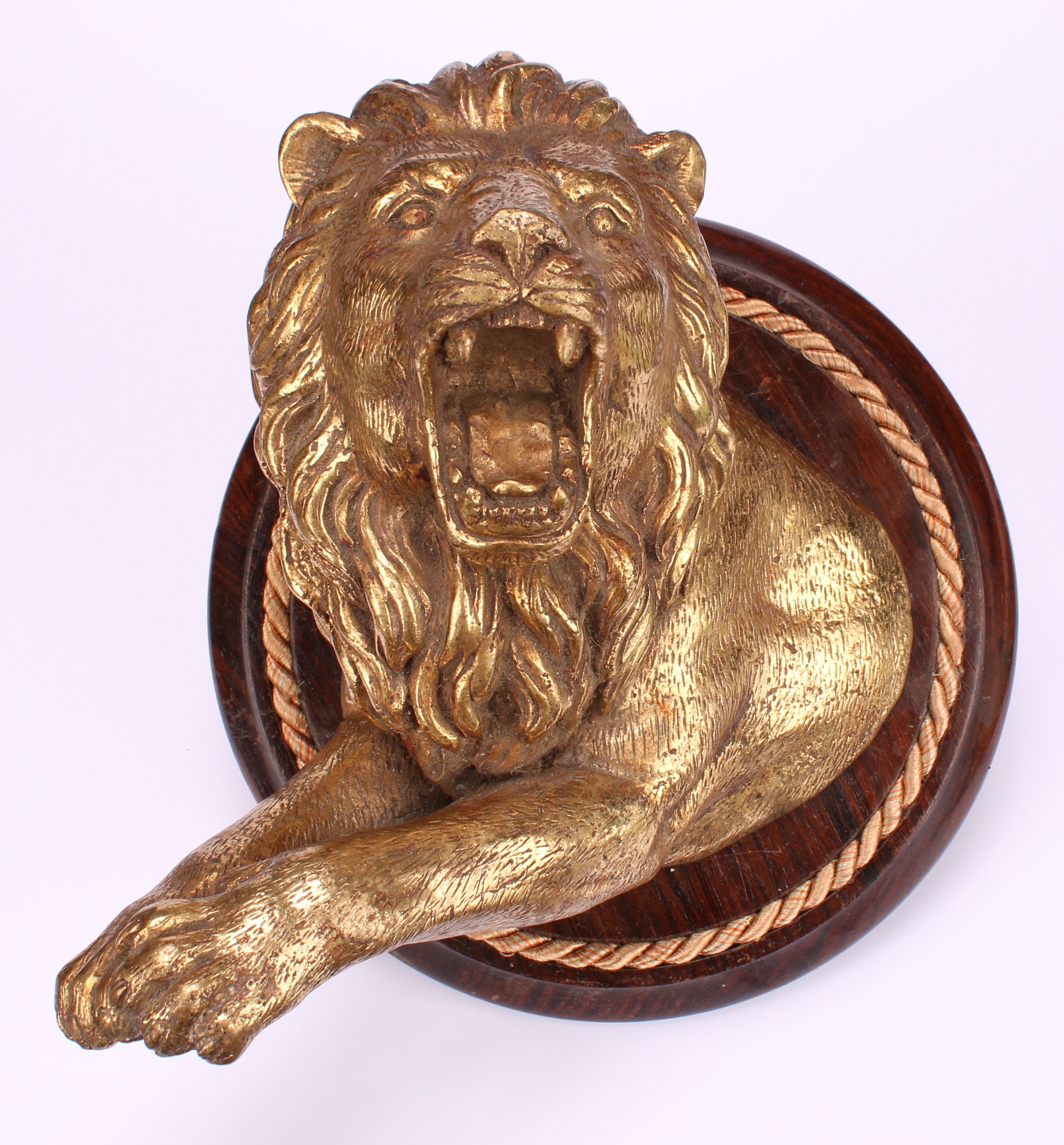 A 19th century gilt metal wall plaque, boldly cast as a ferocious lion, circular rosewood mount, - Image 2 of 2