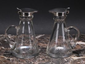 A pair of George V silver mounted conical whisky noggins, hinged covers, loop handles, star-cut
