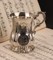 A Victorian silver mug, fluted and engraved with roses and scrolling leaves, acanthus-capped