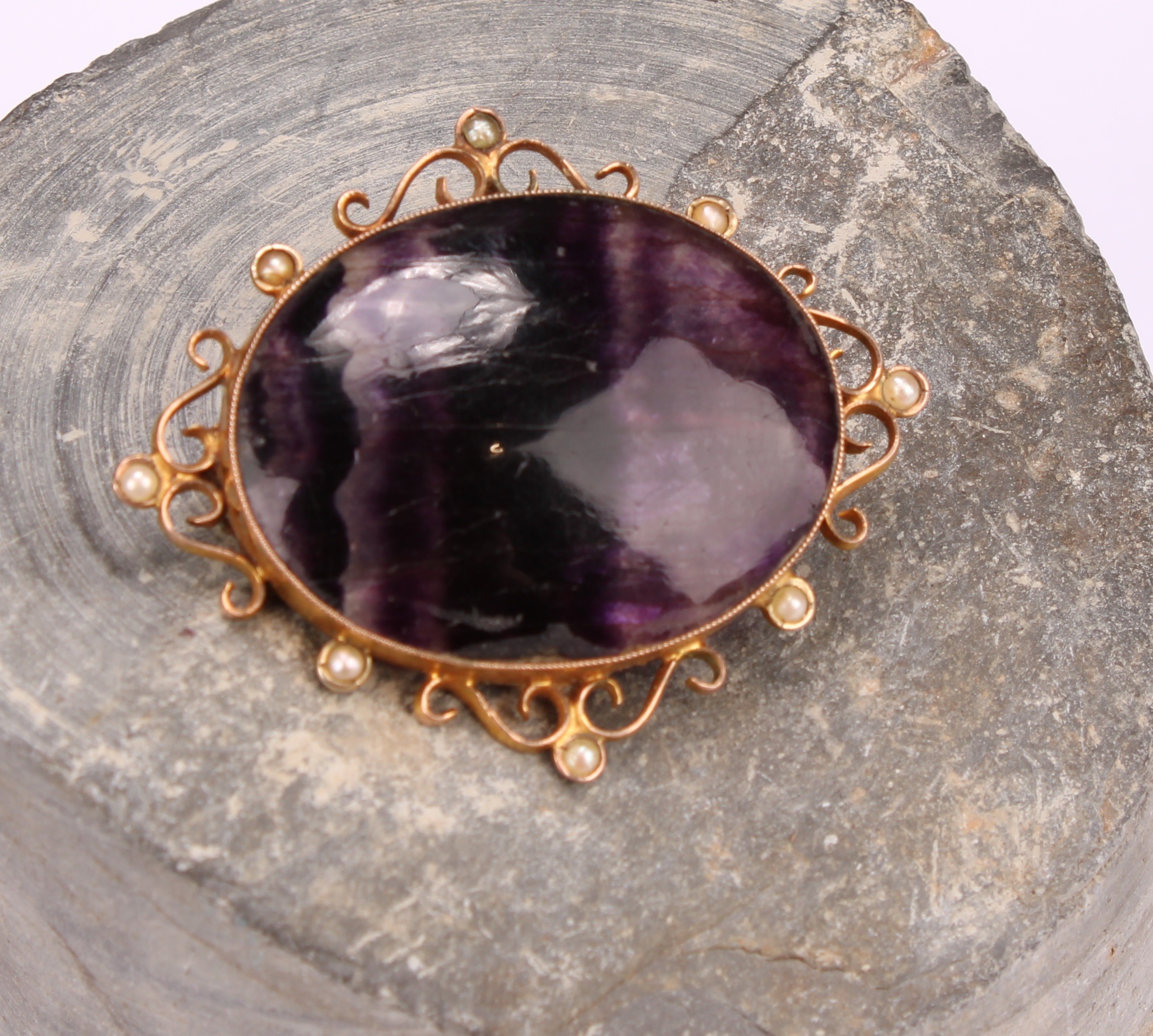 A late 19th century 9ct gold mounted Derbyshire Blue John polished oval brooch, the openwork
