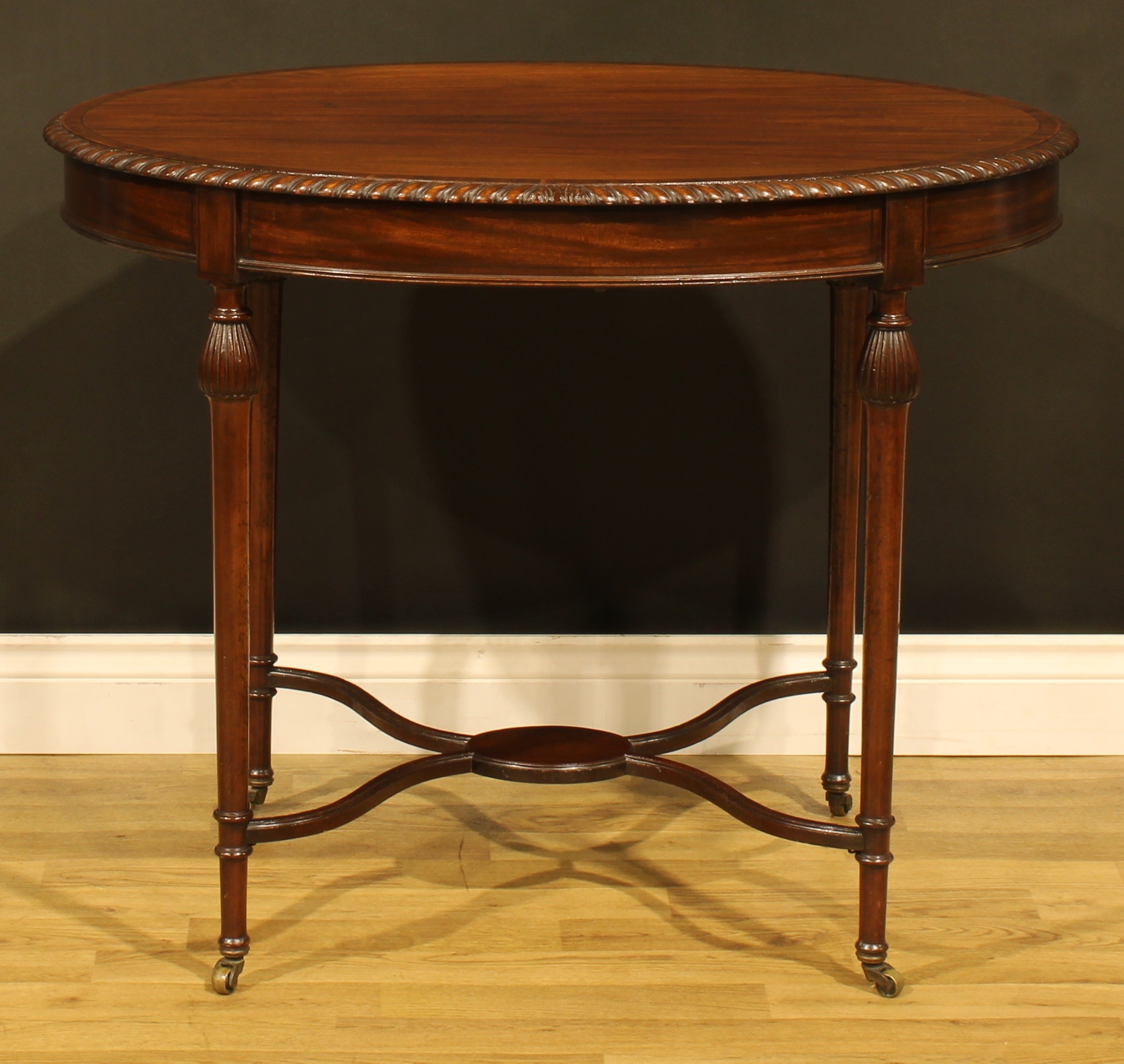 An Edwardian mahogany oval centre table, crossbanded oval top with gadrooned edge, reeded-pear - Image 2 of 5