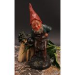 An Austrian terracotta gnome, by Johann Maresch, he stands, beside a barrel, holding a bowling wood,