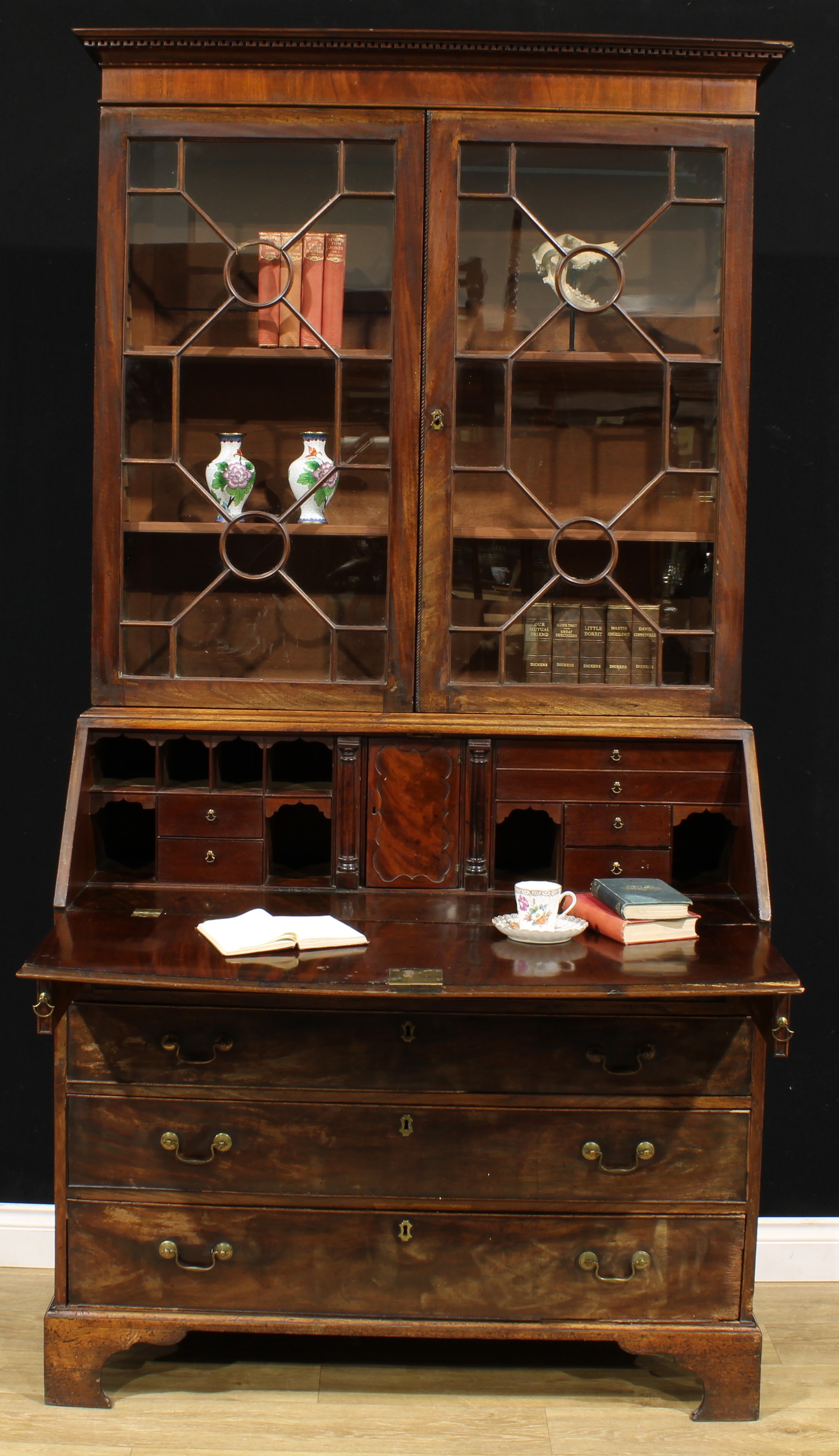 A George III mahogany bureau bookcase, outswept cornice above a pair of astragal glazed doors