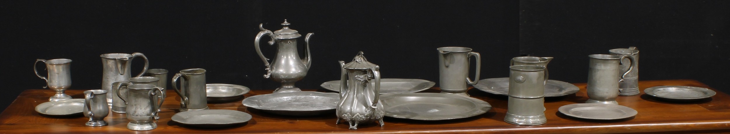 A George III pewter charger, 42.5cm diam, c.1800; others, plates; beer mugs; etc (qty)