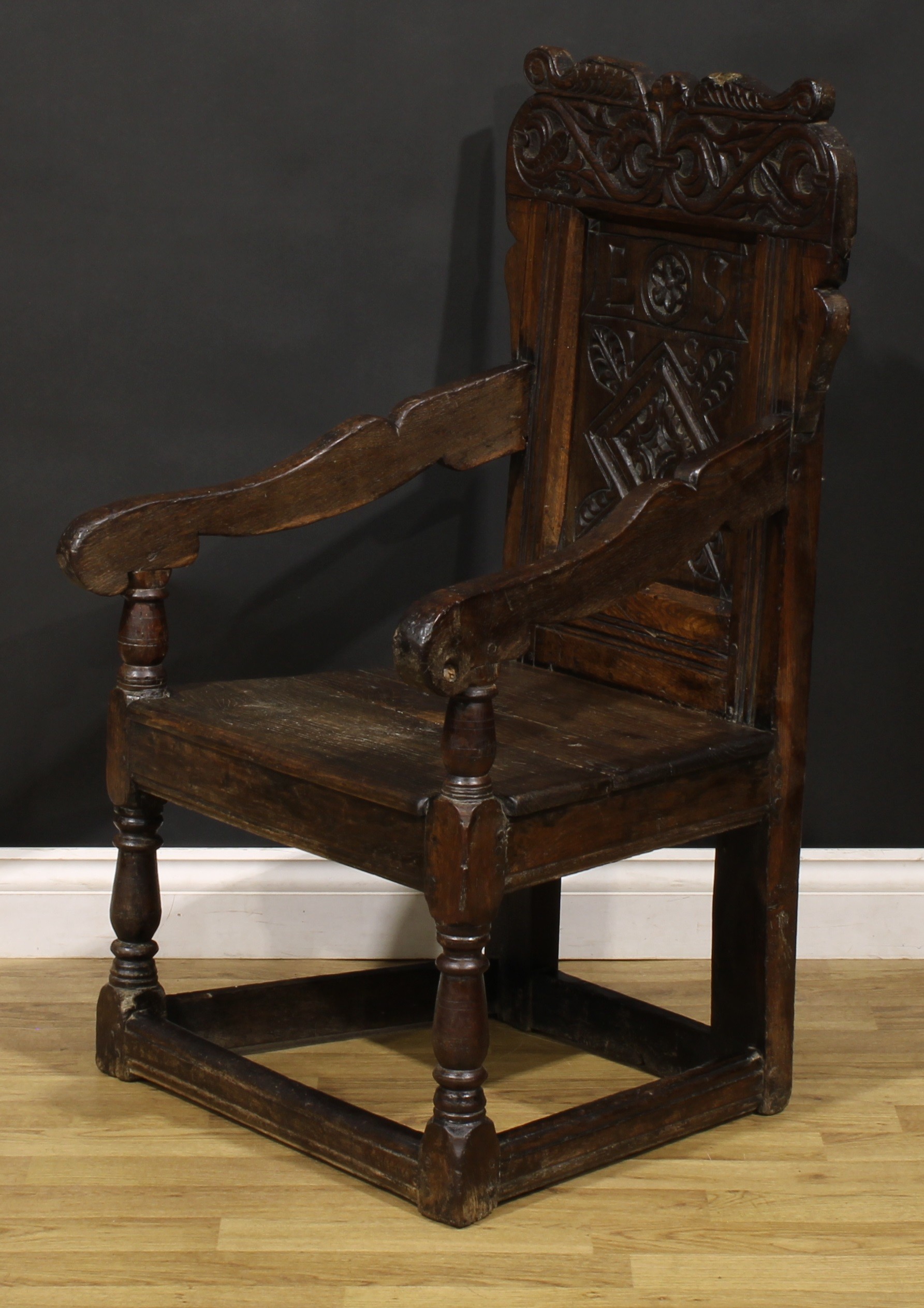 A 17th century oak wainscot armchair, shaped cresting carved with scrolling leafy branches, the - Image 3 of 4