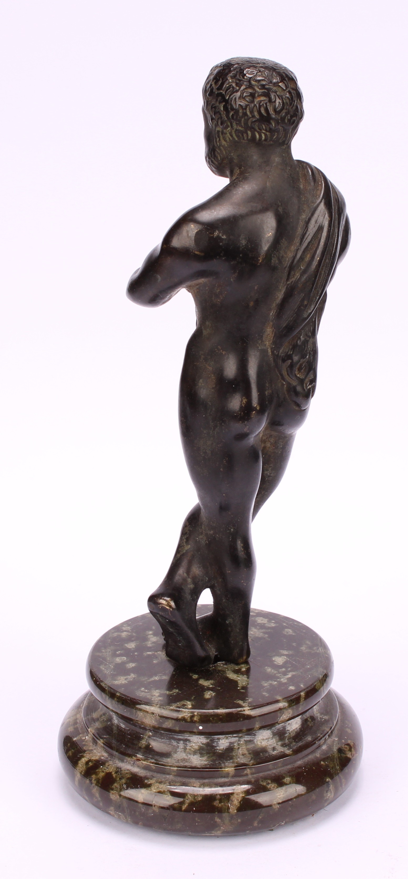 A late 19th century Grand Tour patinated bronze, of Hercules, draped with a pelt, masked club in - Image 4 of 4