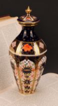 A Royal Crown Derby 1128 Imari pattern tapering hexagonal vase and cover, gilt finial, 24cm high,