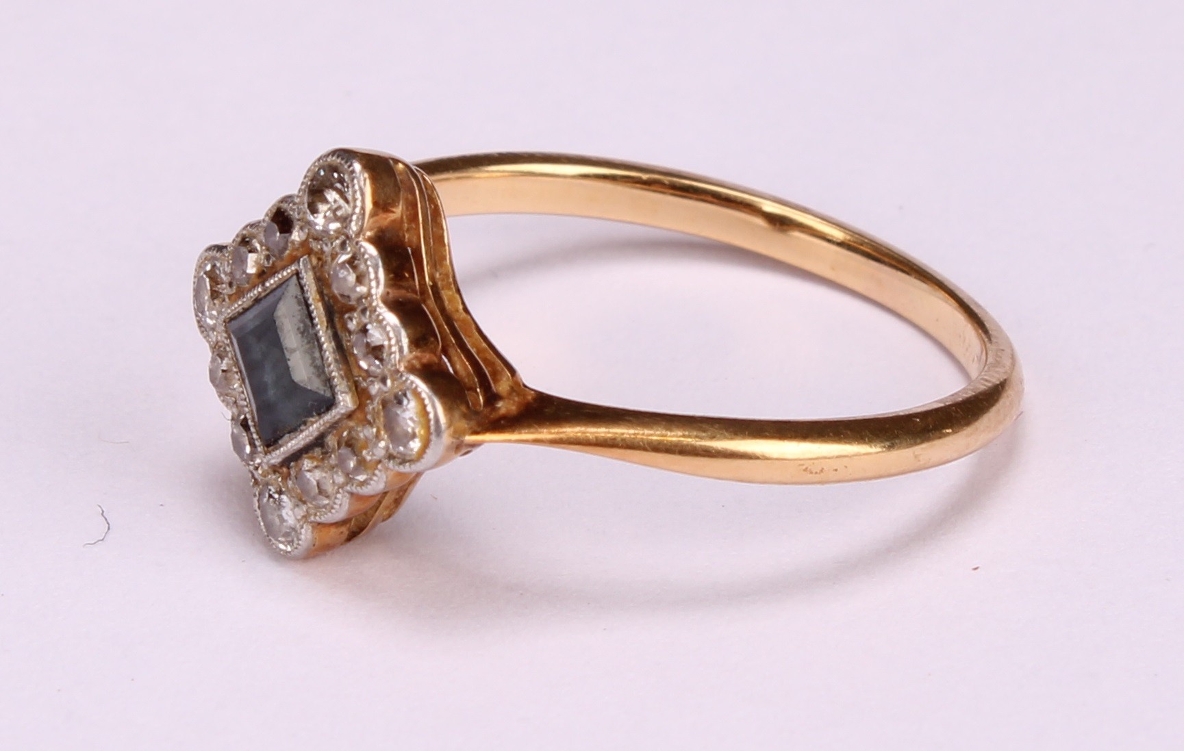 A diamond and sapphire square set cluster ring, the central cushion cut stone within a border of - Image 4 of 8