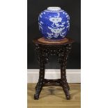 A Chinese hardwood jardiniere stand, circular top with beaded border and inset marble panel,