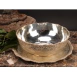An Iranian white metal fruit bowl and stand, profusely chased in the Persian taste with lotus and