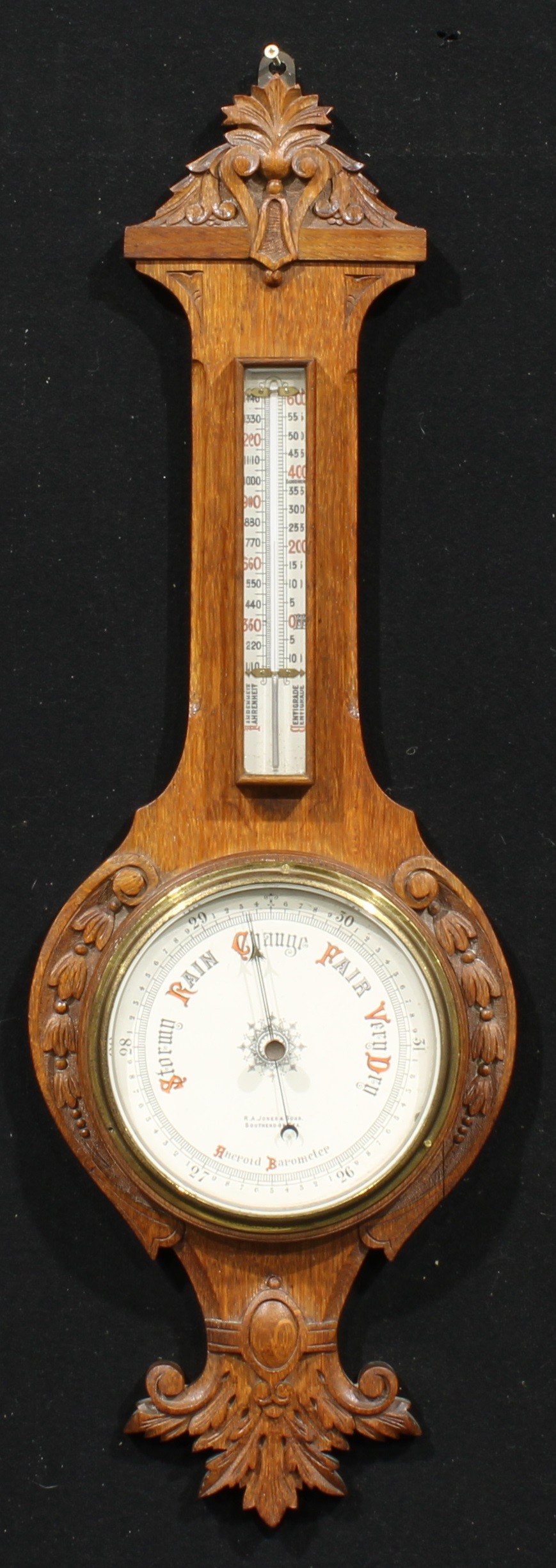 A late Victorian/Edwardian Essex oak wheel barometer, 18.5cm circular register inscribed R.A.